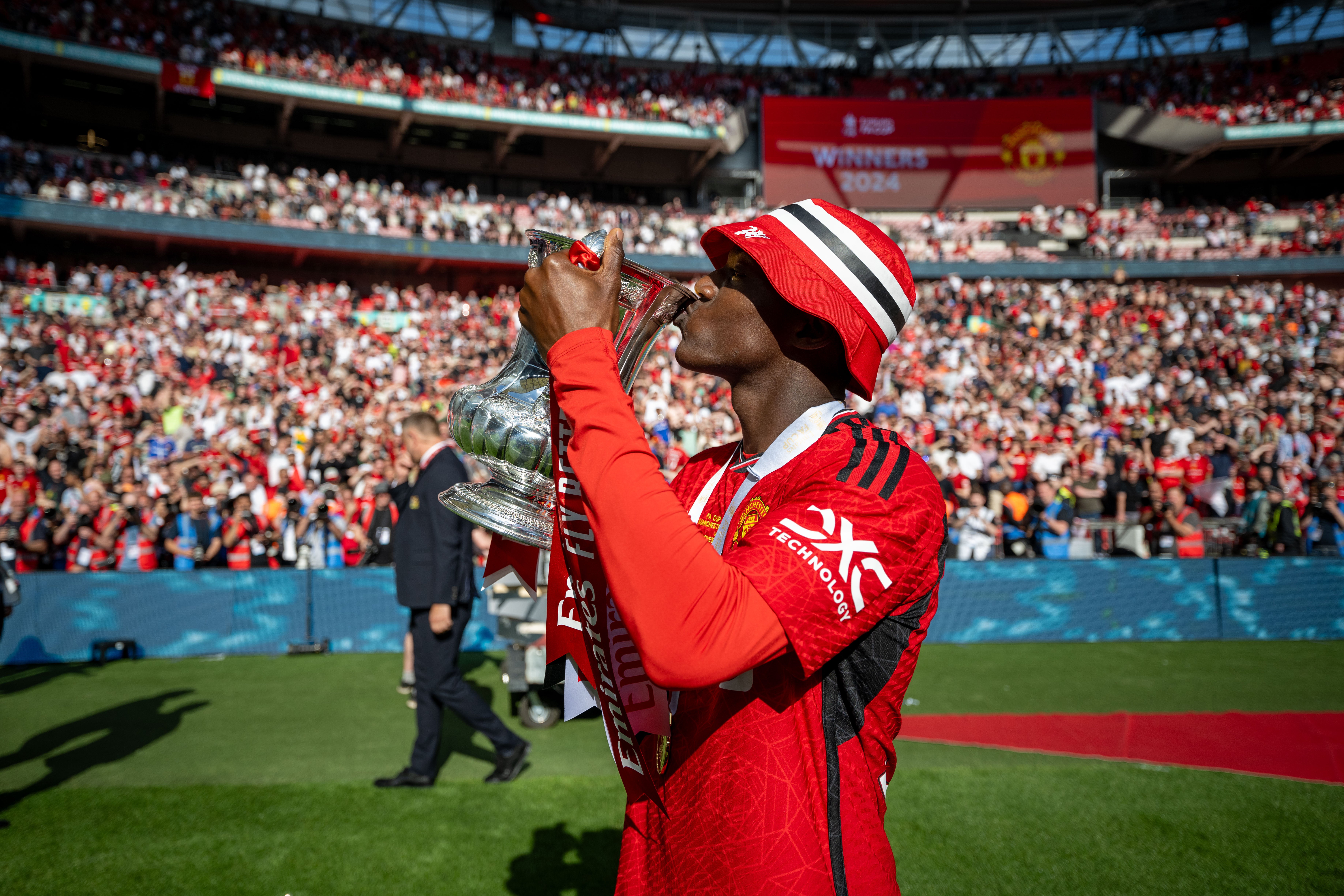 Kobbie Mainoo kisses the FA Cup trophy