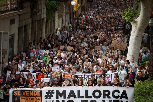 <p>Protesters hold a banner reading "Mallorca is not for sale" during a demonstration to protest against the massification of tourism and housing prices on the island of Mallorca in Palma de Mallorca on May 25, 2024</p>
