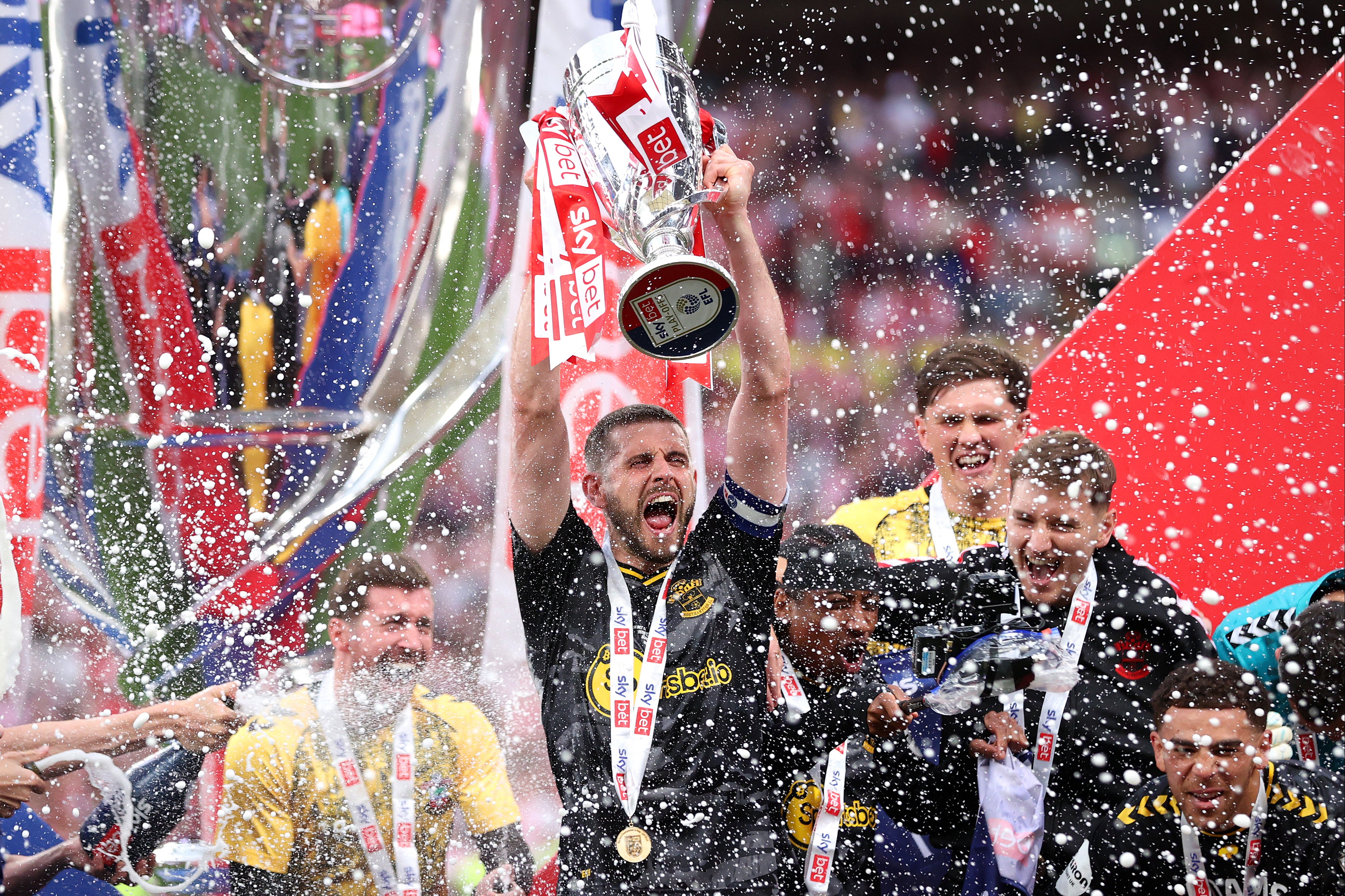Jack Stephens of Southampton lifts the Sky Bet Championship play-off final trophy after his team's victory today