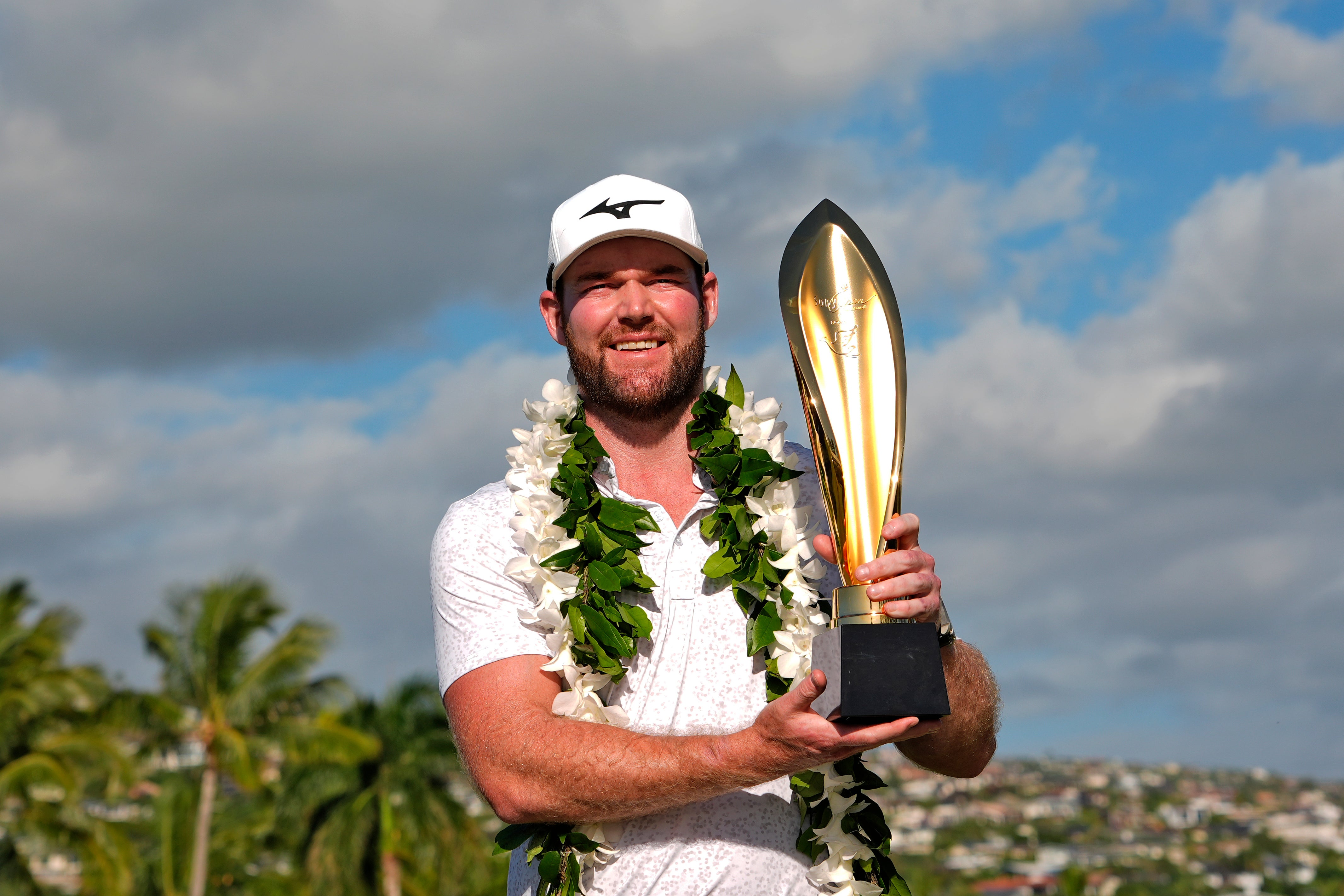 Grayson Murray holds the trophy after winning the Sony Open golf event, Sunday, Jan. 14, 2024, at Waialae Country Club in Honolulu. Two-time PGA Tour winner Grayson Murray died Saturday morning, May 25, 2024 at age 30, one day after he withdrew from the Charles Schwab Cup Challenge at Colonial(AP Photo/Matt York, File)