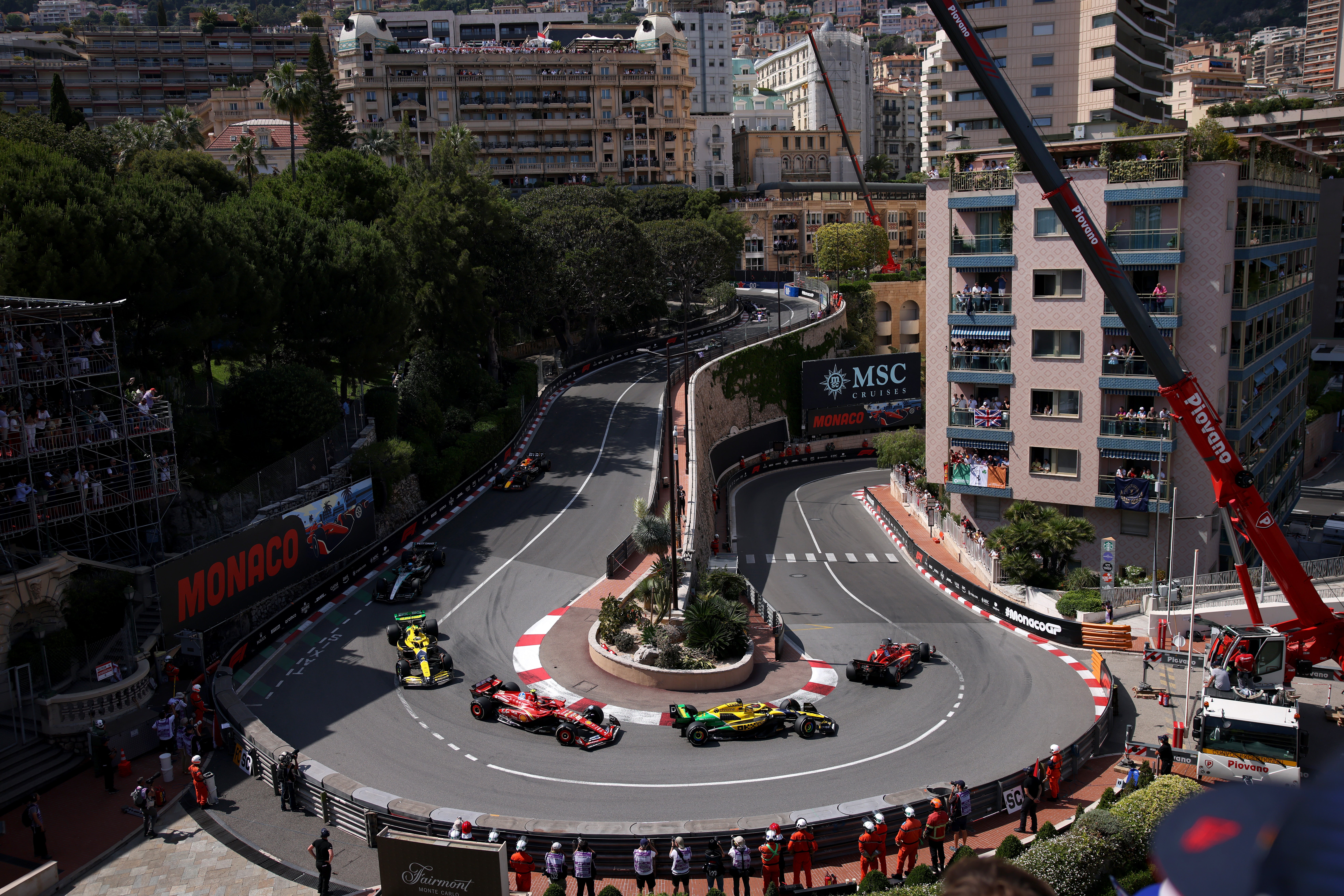 The front four cars stay in position around the Grand Hotel hairpin