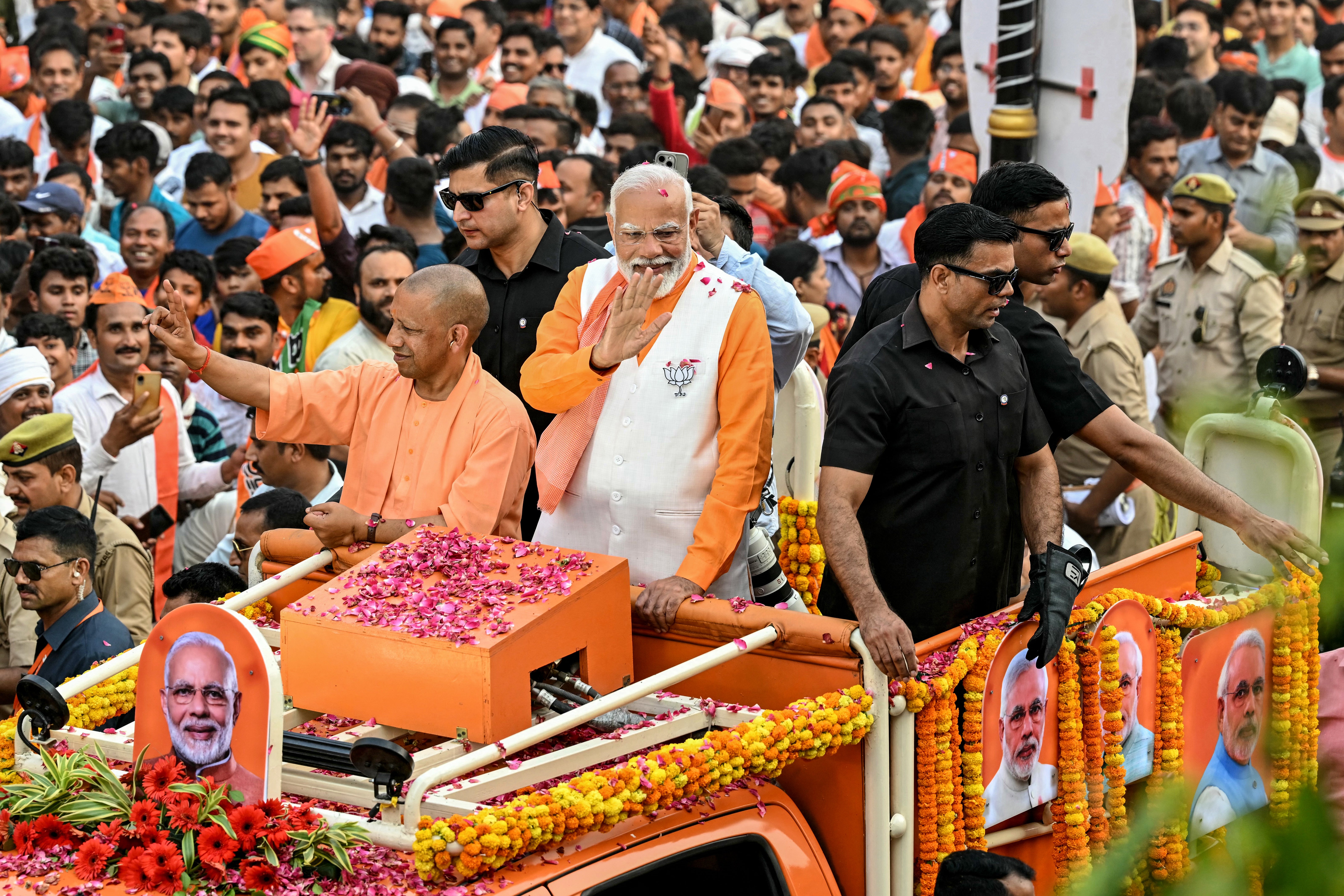 Narendra Modi with Yogi Adityanath, chief minister of Uttar Pradesh, waves to the crowd in Varanasi last month