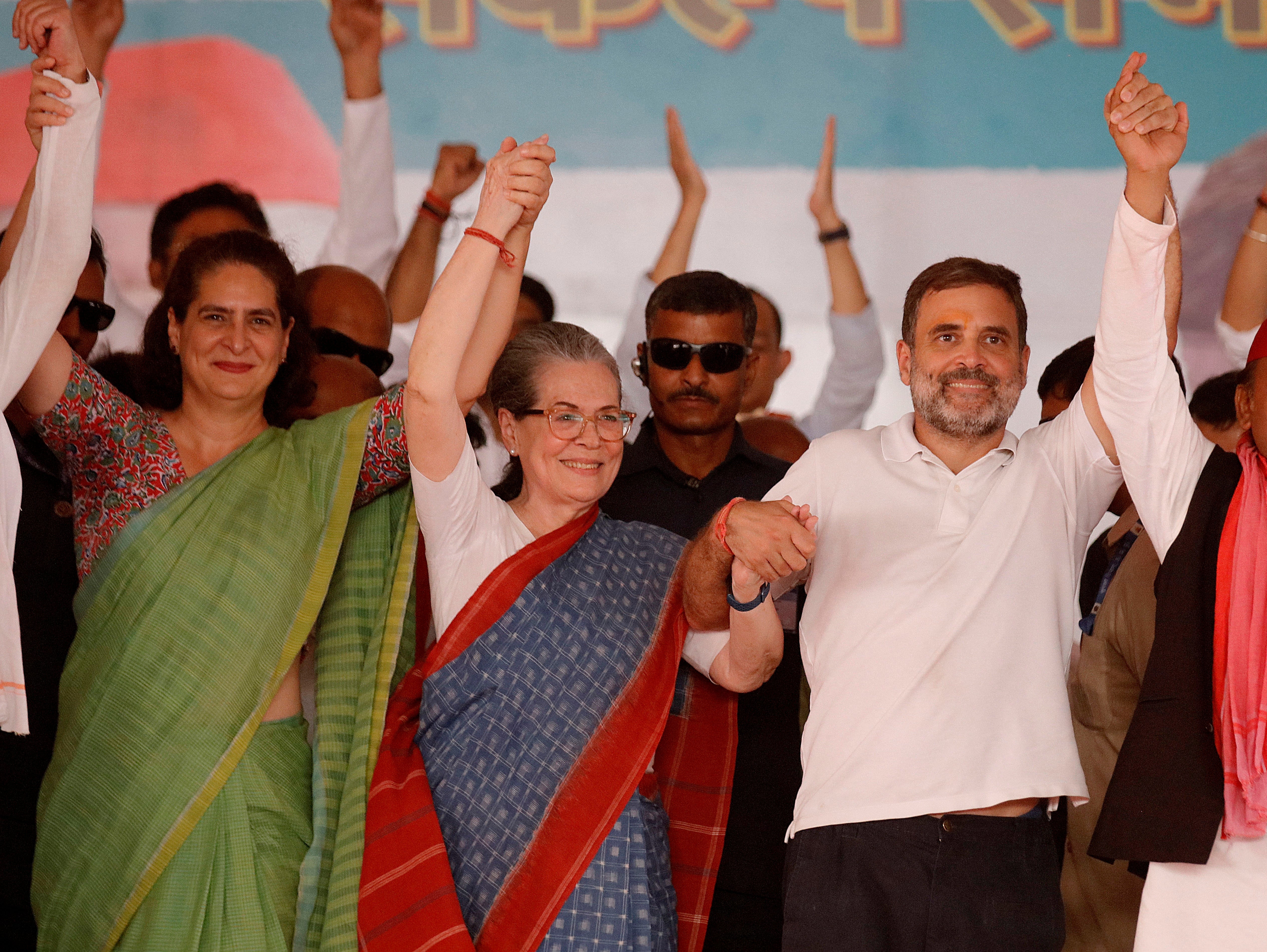 Priyanka Gandhi, Rahul Gandhi and Sonia Gandhi join their hands together during an election campaign rally in Raebareli