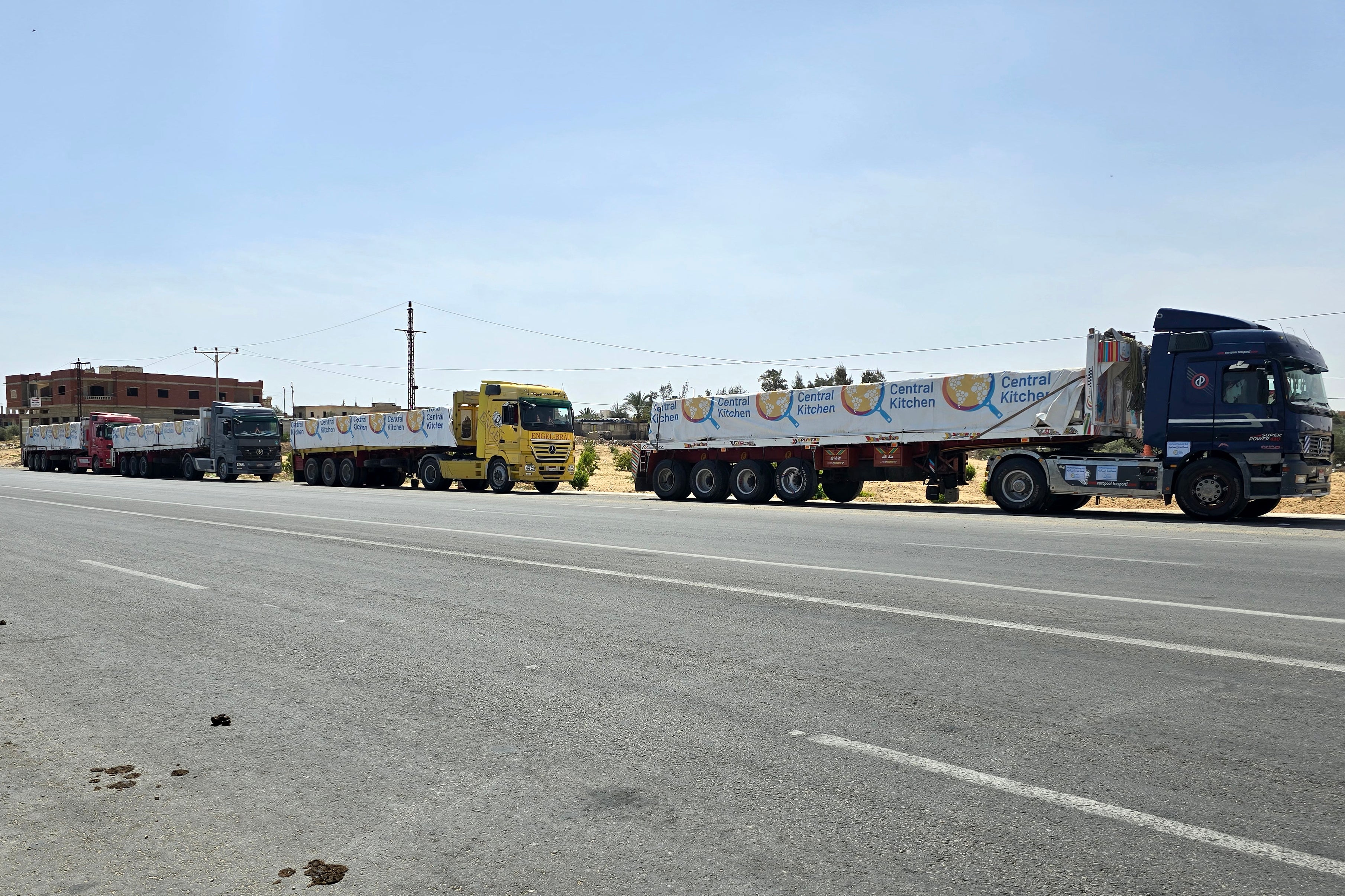Egyptian trucks carrying humanitarian aid bound for the Gaza Strip wait near the Rafah border on Sunday
