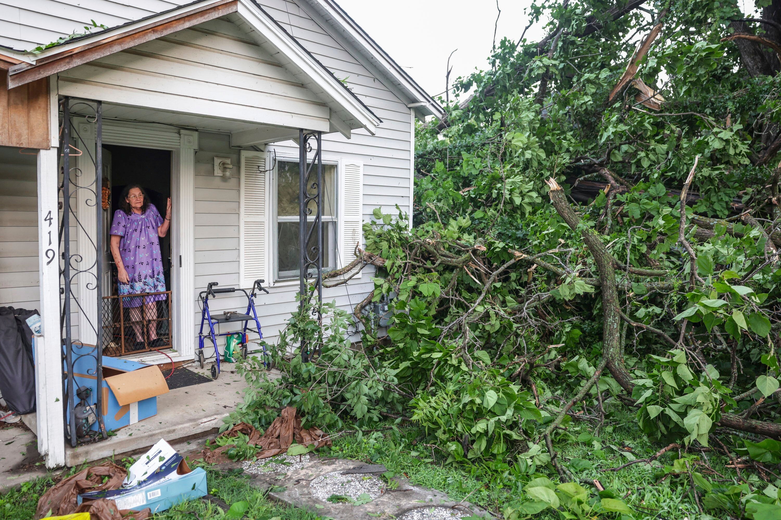 Connie Buckingham views storm damage from the front door of her son's home, where she also lives, Sunday, May 26, 2024, in Claremore, Okla