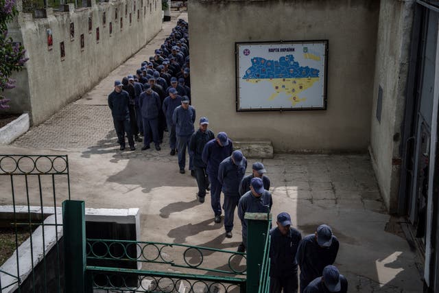 <p>Captured Russian soldiers walk in line to a dining room at the prisoner of war detention center in Ukraine's Lviv region, Thursday, April 25, 2024</p>