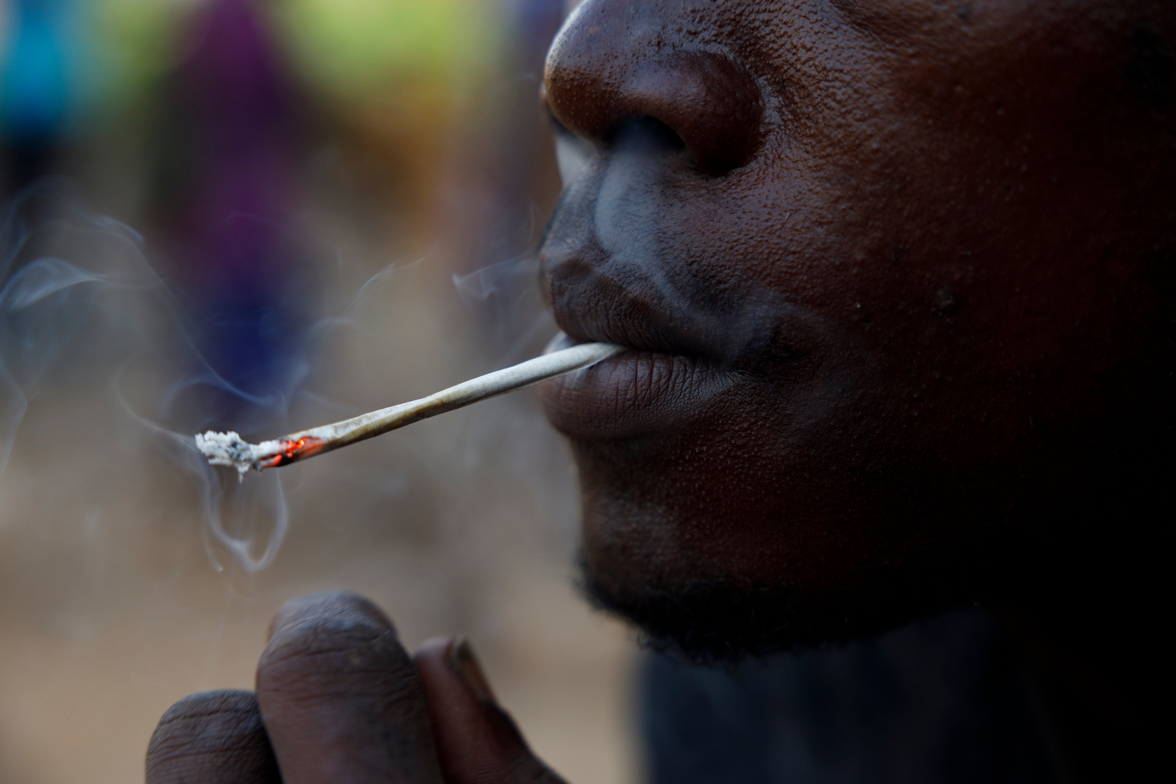 A young man smokes kush in a hideout in Freetown, Sierra Leone, Monday, April 29, 2024