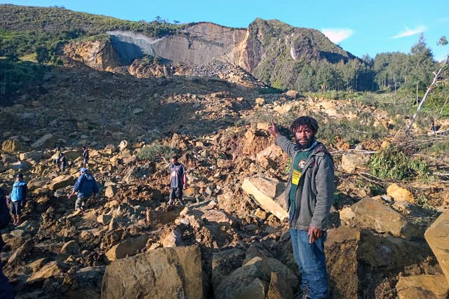 <p>People gather at the site of a landslide in Maip Mulitaka in Papua New Guinea’s Enga Province</p>