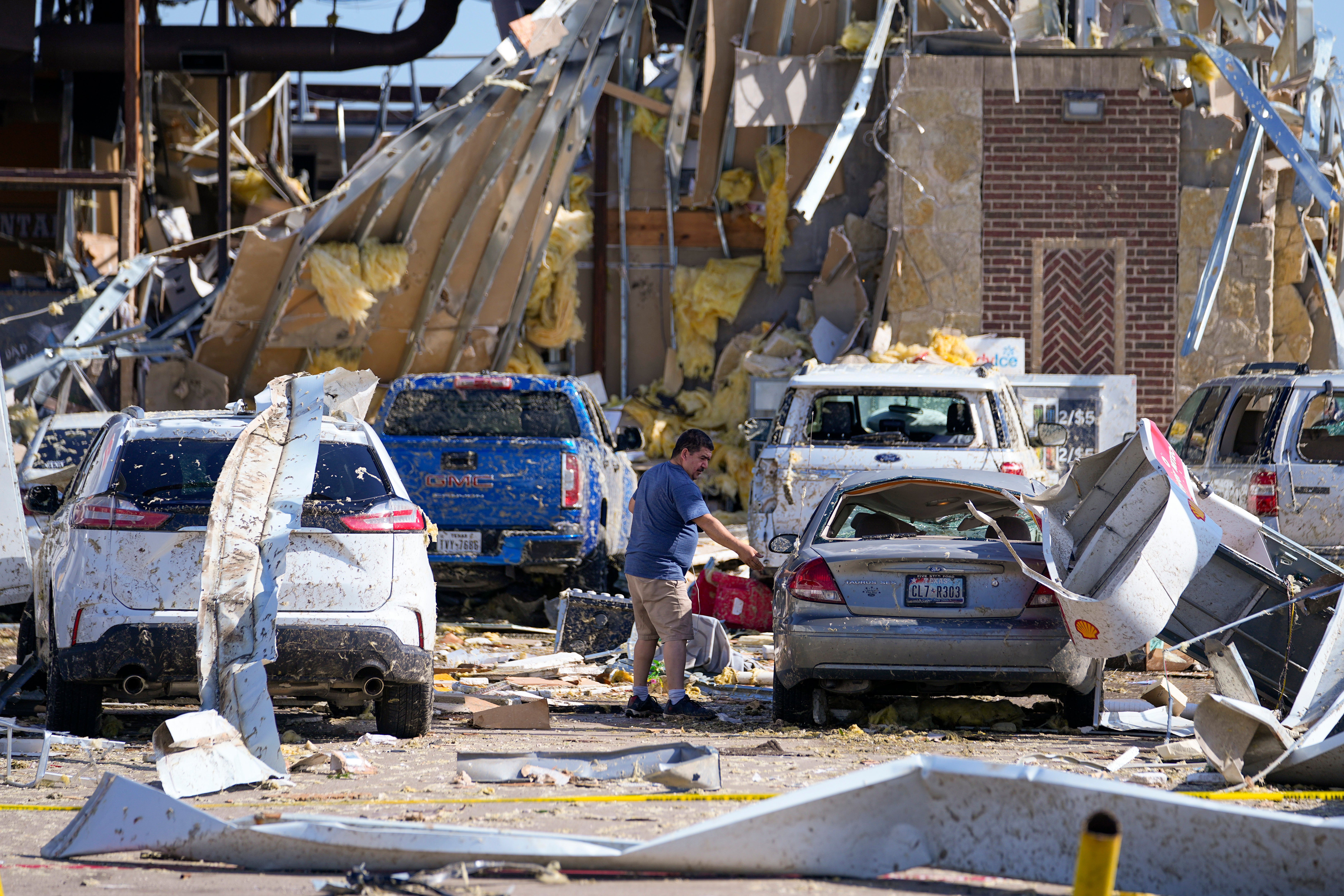 Damaged cars and buildings after a tornado hit Texas