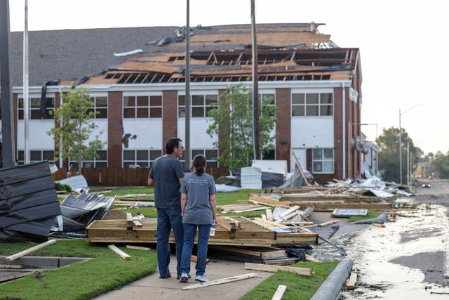 Claremore, Oklahoma residents survey damage to a church on Sunday. The powerful storms damaged dozens of buildings in the small town