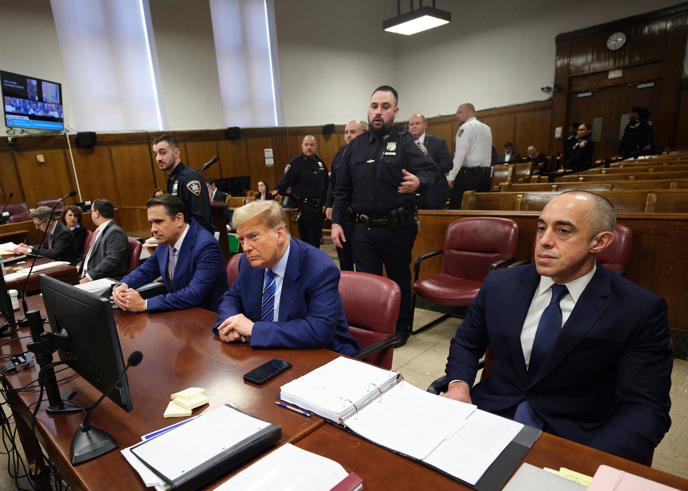 Donald Trump sits at the defense table in his hush money trial