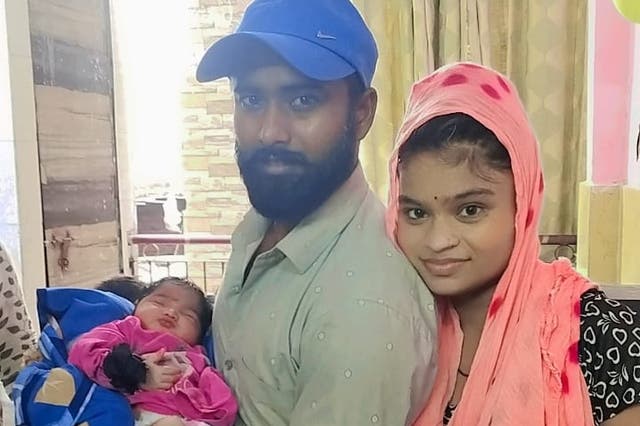 <p>Newborn baby Ruhi, pictured here before the fire at home with her parents, is one of seven killed in the blaze </p>