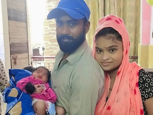 <p>Newborn baby Ruhi, pictured here before the fire at home with her parents, is one of seven killed in the blaze </p>