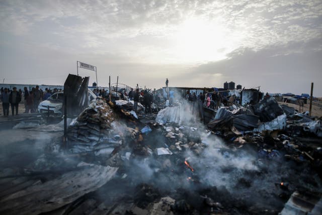 <p>Palestinians look at the destruction after an Israeli strike where displaced people were staying in Rafah, Gaza Strip on May 27, 2024</p>