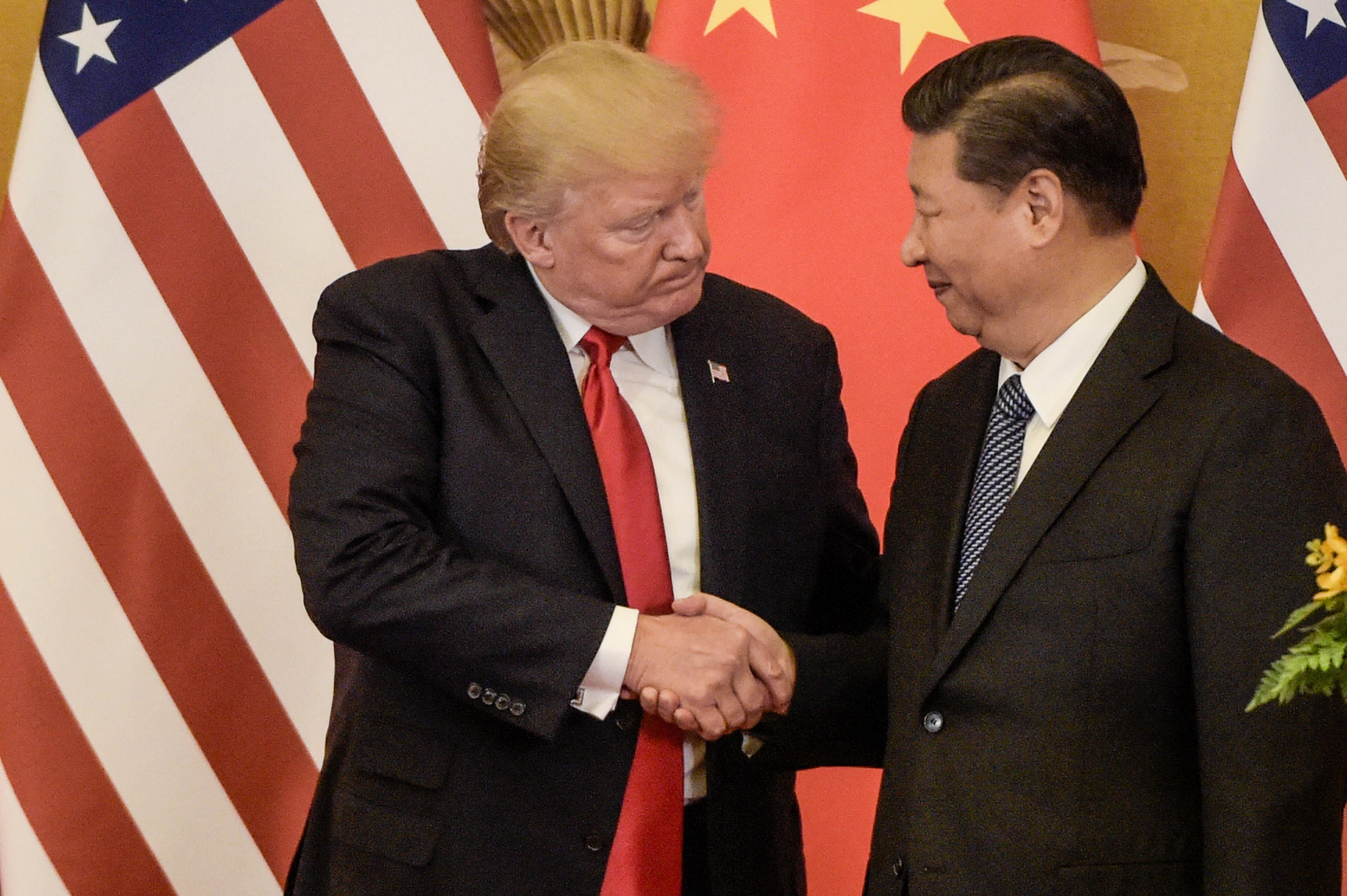 US President Donald Trump (L) shakes hand with China's President Xi Jinping at the end of a press conference at the Great Hall of the People in Beijing on November 9, 2017