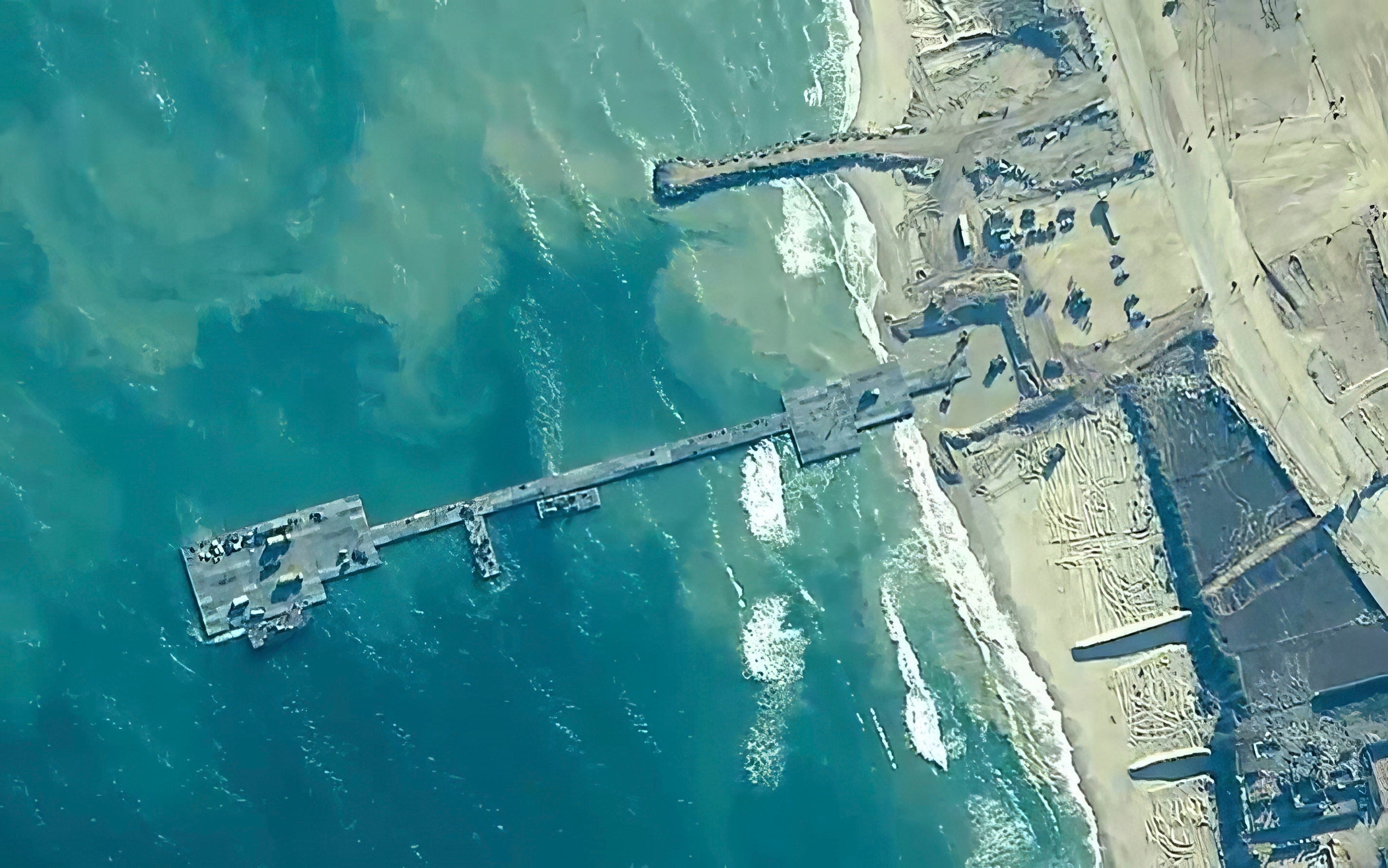 The image provided by U.S. Central Command shows the Trident Pier on the coast of Gaza Strip on May 16, 2024, before it was damaged
