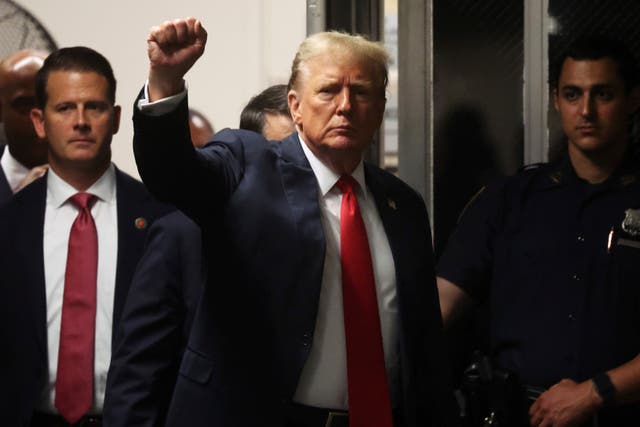 Former President Donald Trump reacts as he walking back into the courtroom after a break during closing arguments in his criminal hush money trial