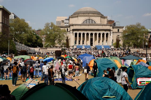 <p>Student protesters gather inside their encampment on the Columbia University campus in April </p>
