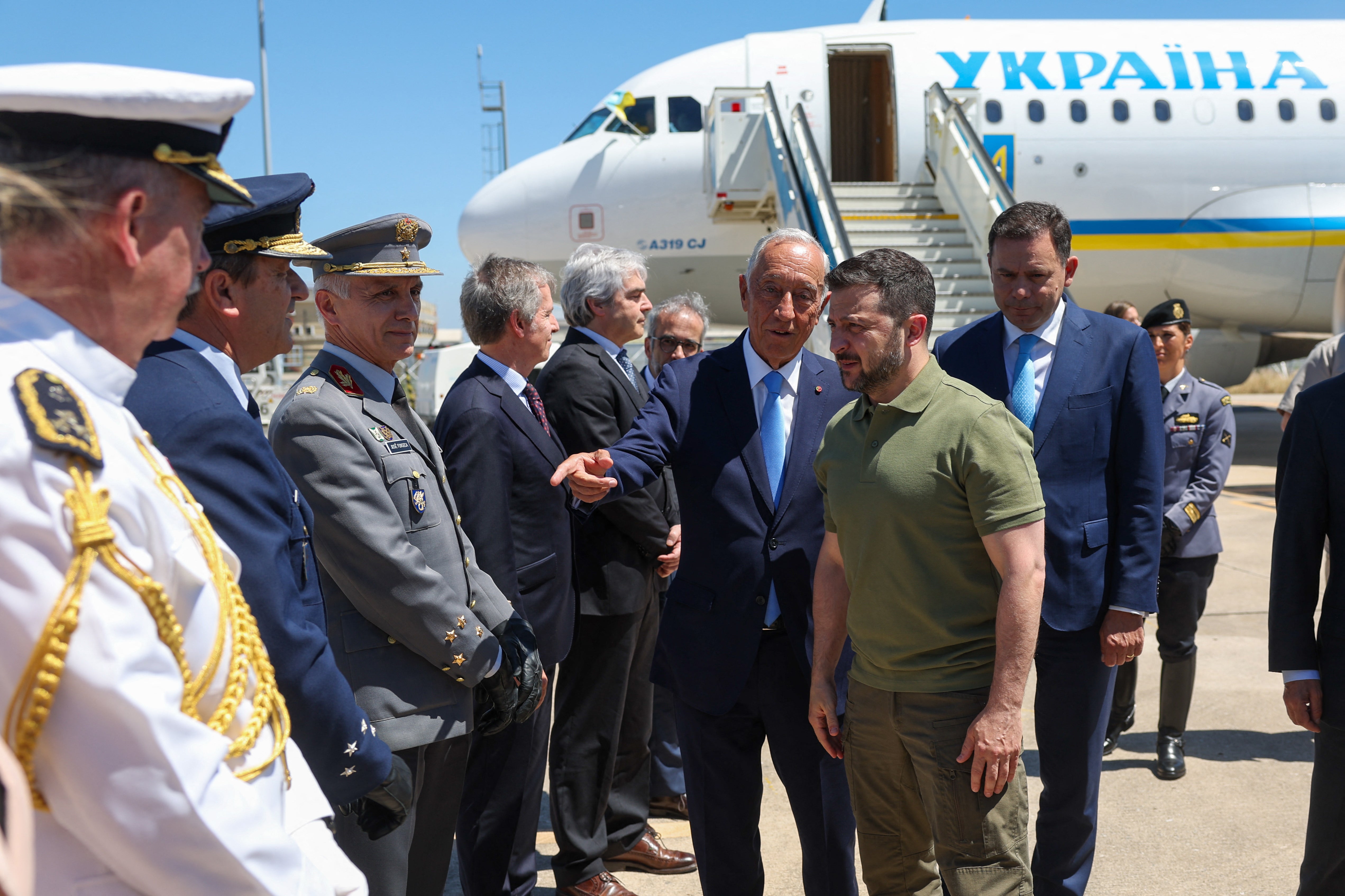 Portuguese Prime Minister Luis Montenegro (R) and Portuguese President Marcelo Rebelo de Sousa (C) review the guard of honour with Ukraine's President Volodymyr Zelensky upon his arrival at Figo Maduro military airport in Lisbon