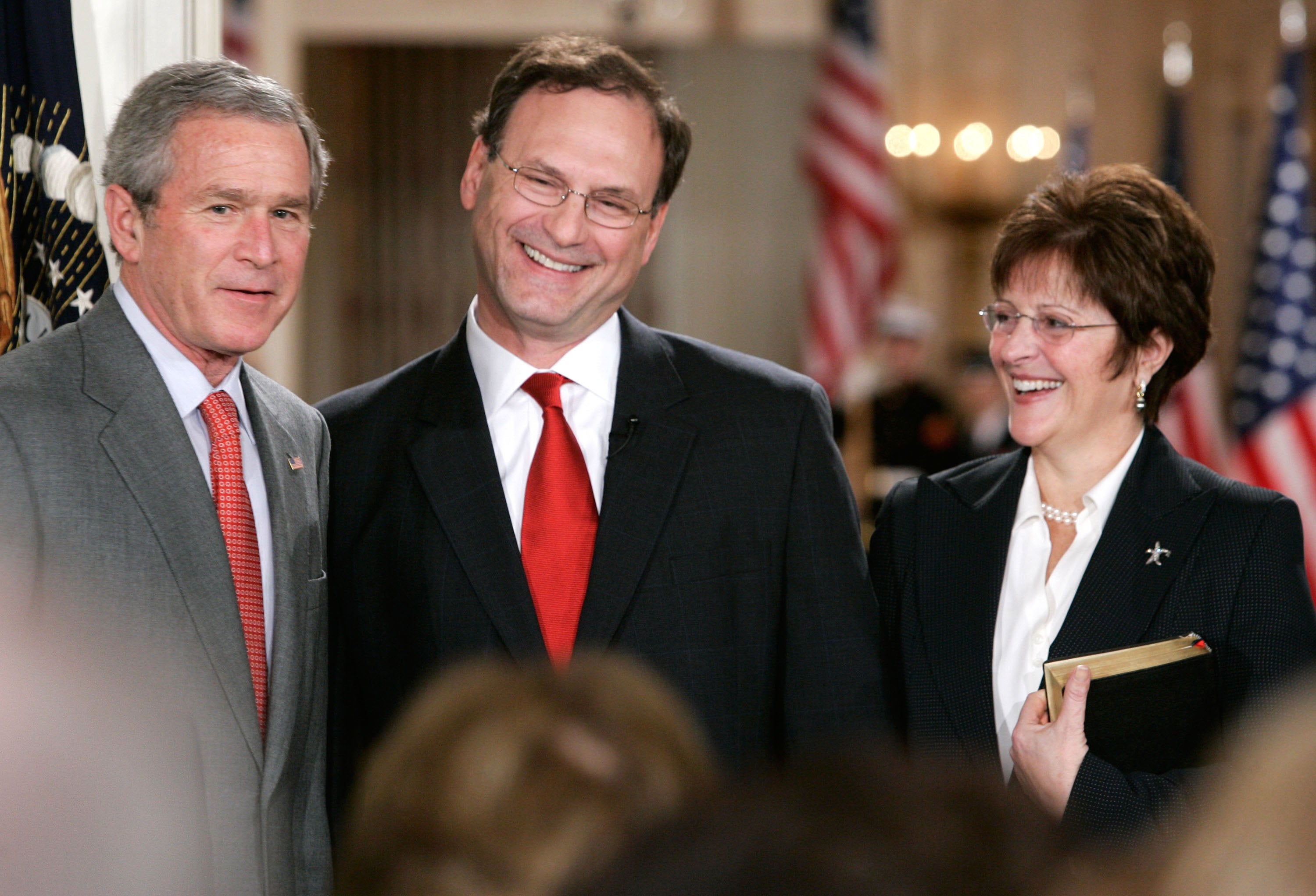 President George W Bush, Supreme Court Justice Samuel Alito and his Martha-Ann Bomgardner share a smile during a ceremonial swearing-in at the East Room of the White House in February 2006