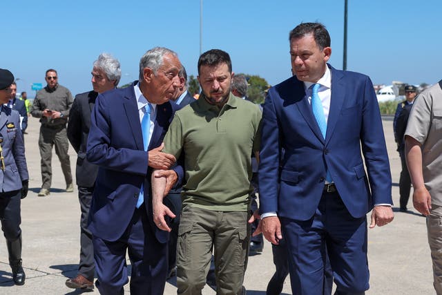 <p>Portuguese head of state Marcelo Rebelo de Sousa, left, and Portuguese prime minister Luis Montenegro, right, welcome Ukraine's President Volodymyr Zelensky, centre, on his arrival at Figo Maduro air base</p>