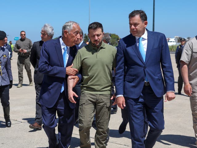 <p>Portuguese head of state Marcelo Rebelo de Sousa, left, and Portuguese prime minister Luis Montenegro, right, welcome Ukraine's President Volodymyr Zelensky, centre, on his arrival at Figo Maduro air base</p>