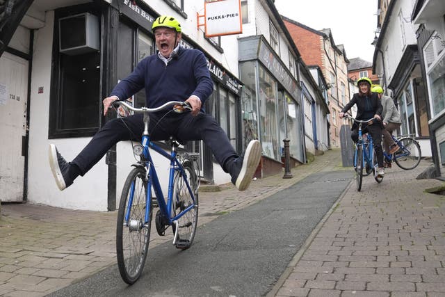 Lib Dem leader Sir Ed Davey enjoyed a bike ride down a hill during a visit to Knighton in Wales (Jacob King/PA)