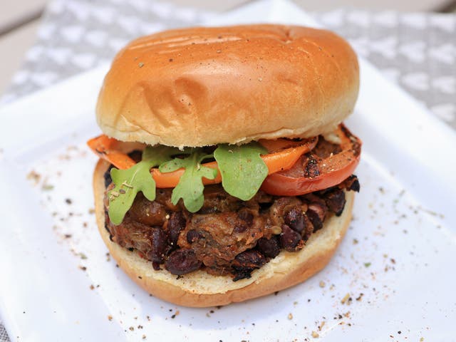 <p>Pulled aubergine and black bean BBQ burgers, served with coleslaw and garnished with rocket and coriander, perfect for a vegan summer grill</p>