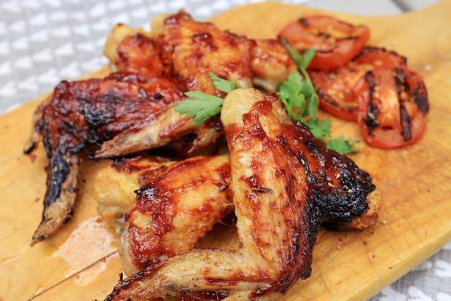 <p>Sizzling sticky BBQ chicken thighs glazed with homemade sauce and garnished with rocket leaves, perfect for summer grilling</p>