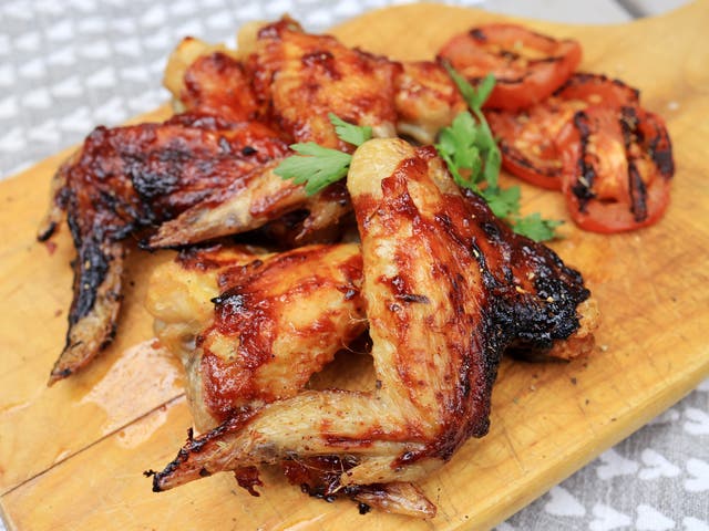 <p>Sizzling sticky BBQ chicken thighs glazed with homemade sauce and garnished with rocket leaves, perfect for summer grilling</p>