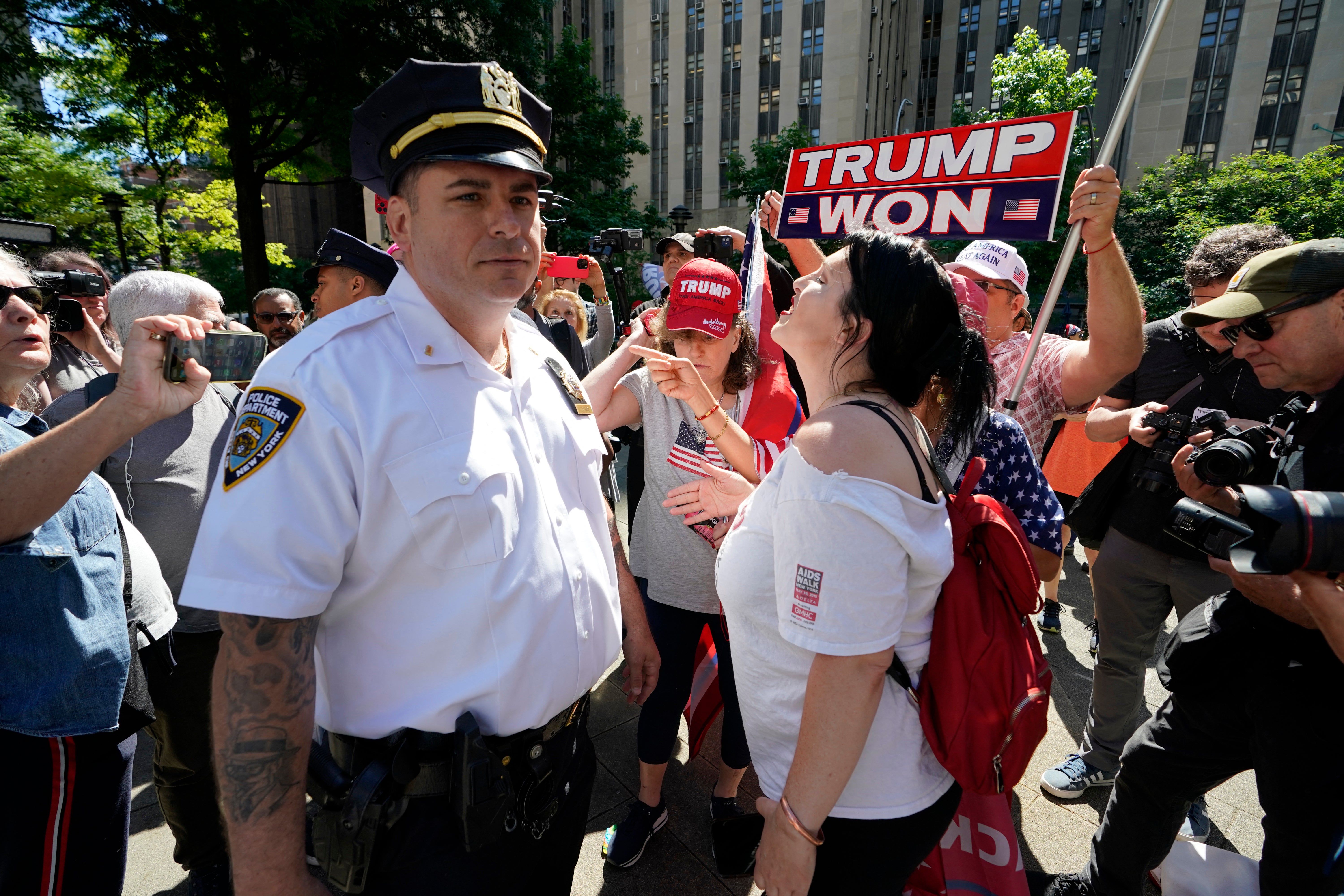 However, several large police agencies such as the New York City police and Los Angeles police do not report to the FBI system. Pictured: A New York City Police Department officer looks on as Trump supporters gather outside of Manhattan Criminal Court