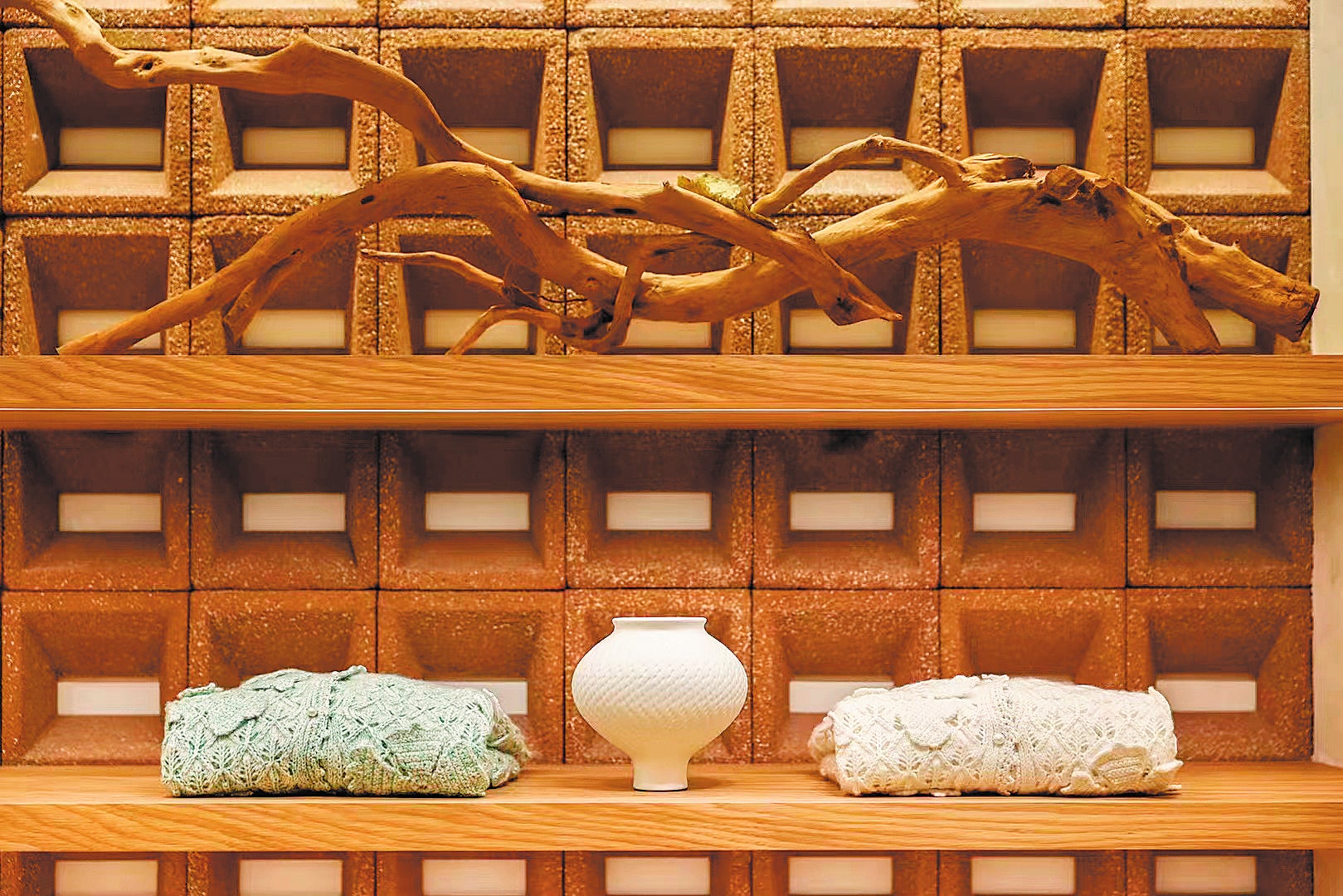 Hollow bricks made of waste ceramics are used as a backdrop for products at a wool sweater store in Shanghai