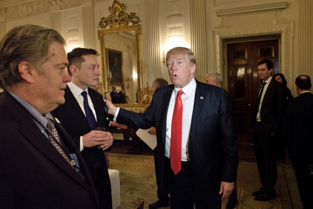 Donald Trump and Elon Musk are pictured in the White House at an event in 2017 along with Steve Bannon, former White House chief strategist