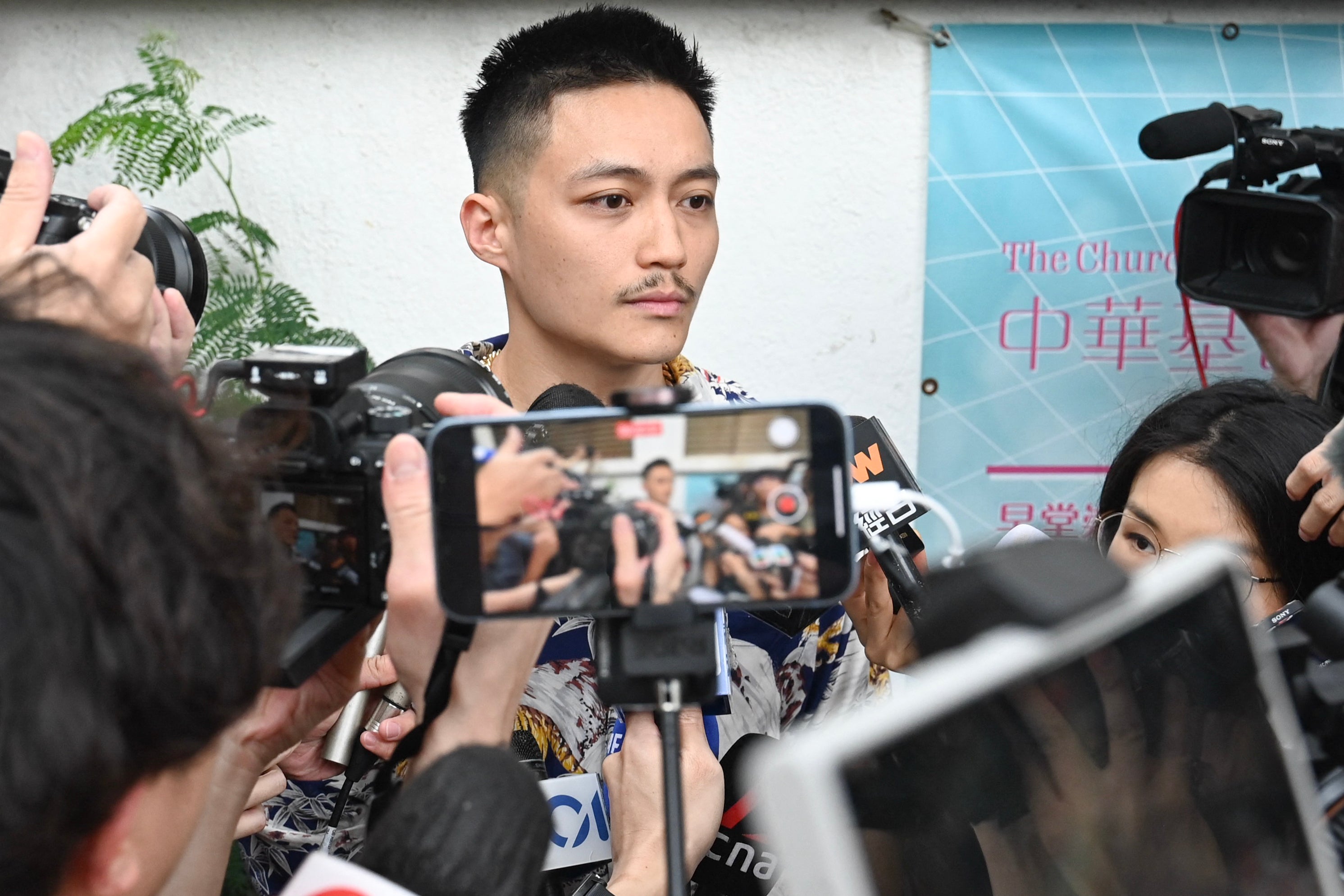 Former district councillor Shun Lee talks to the media after being found not guilty at the West Kowloon Magistrates' Court in Hong Kong