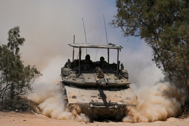<p>sraeli soldiers drive a tank near the Israeli-Gaza border</p>