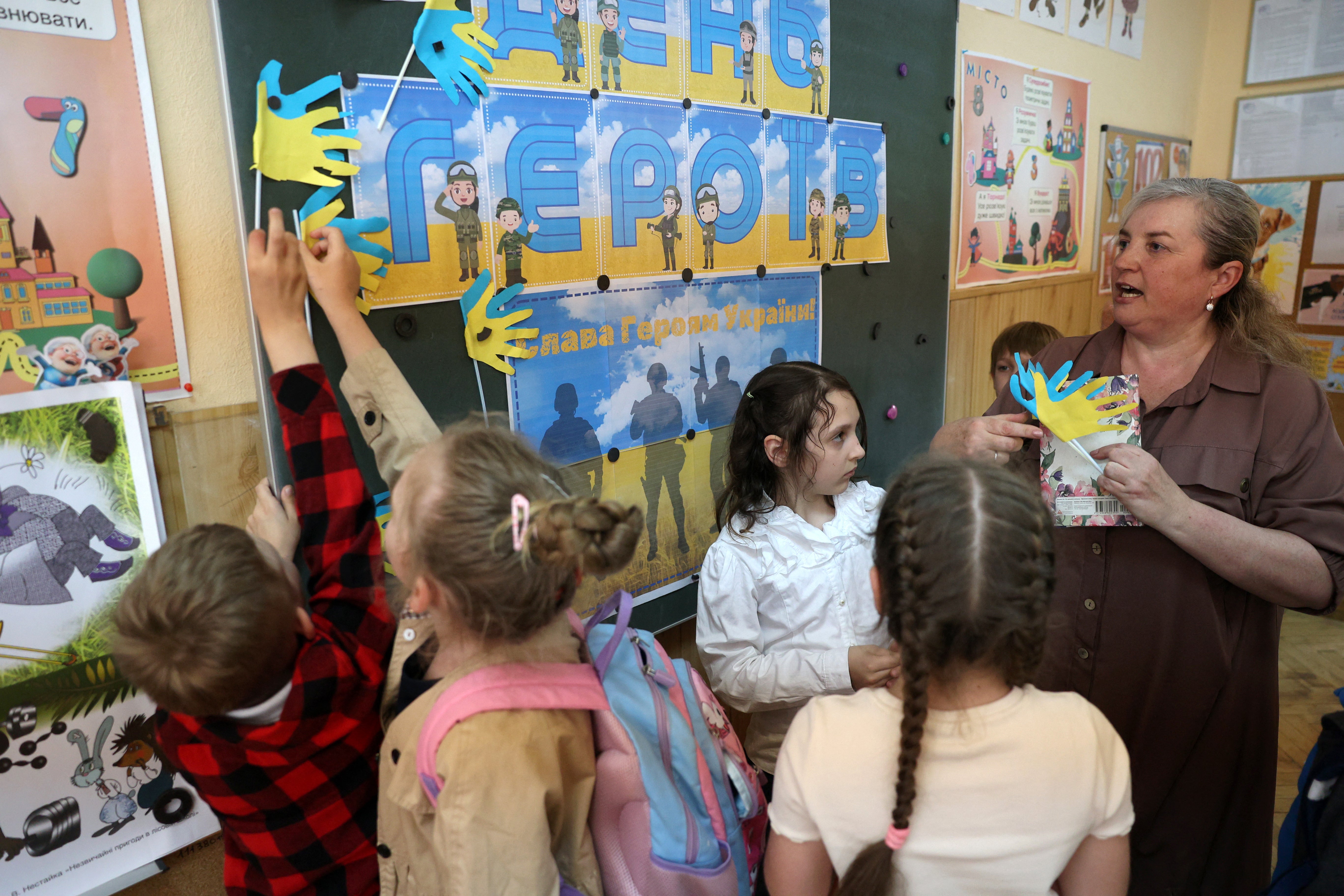 Elementary school teacher Natalya Pyasetska teaches her students during a lesson dedicated to Heroes' Day at the 61st secondary school in Kyiv.