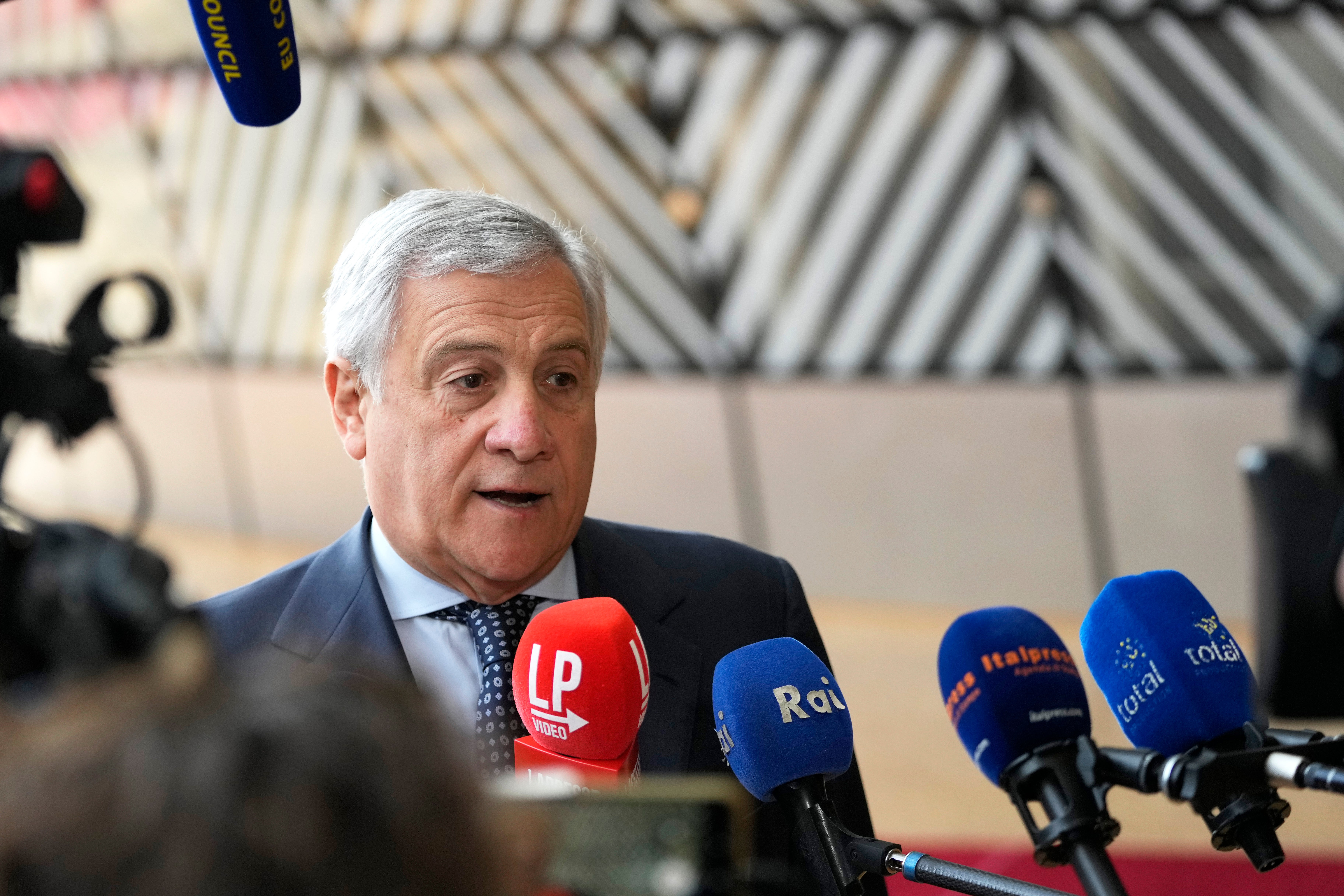 Italy's Foreign Minister Antonio Tajani speaks to the media as he arrives for a meeting of EU foreign ministers at the European Council building in Brussels
