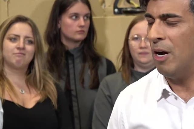 <p>Worker pulls faces as Rishi Sunak says ‘life has been difficult’ in election campaign speech.</p>