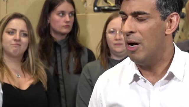 <p>Worker pulls faces as Rishi Sunak says ‘life has been difficult’ in election campaign speech.</p>