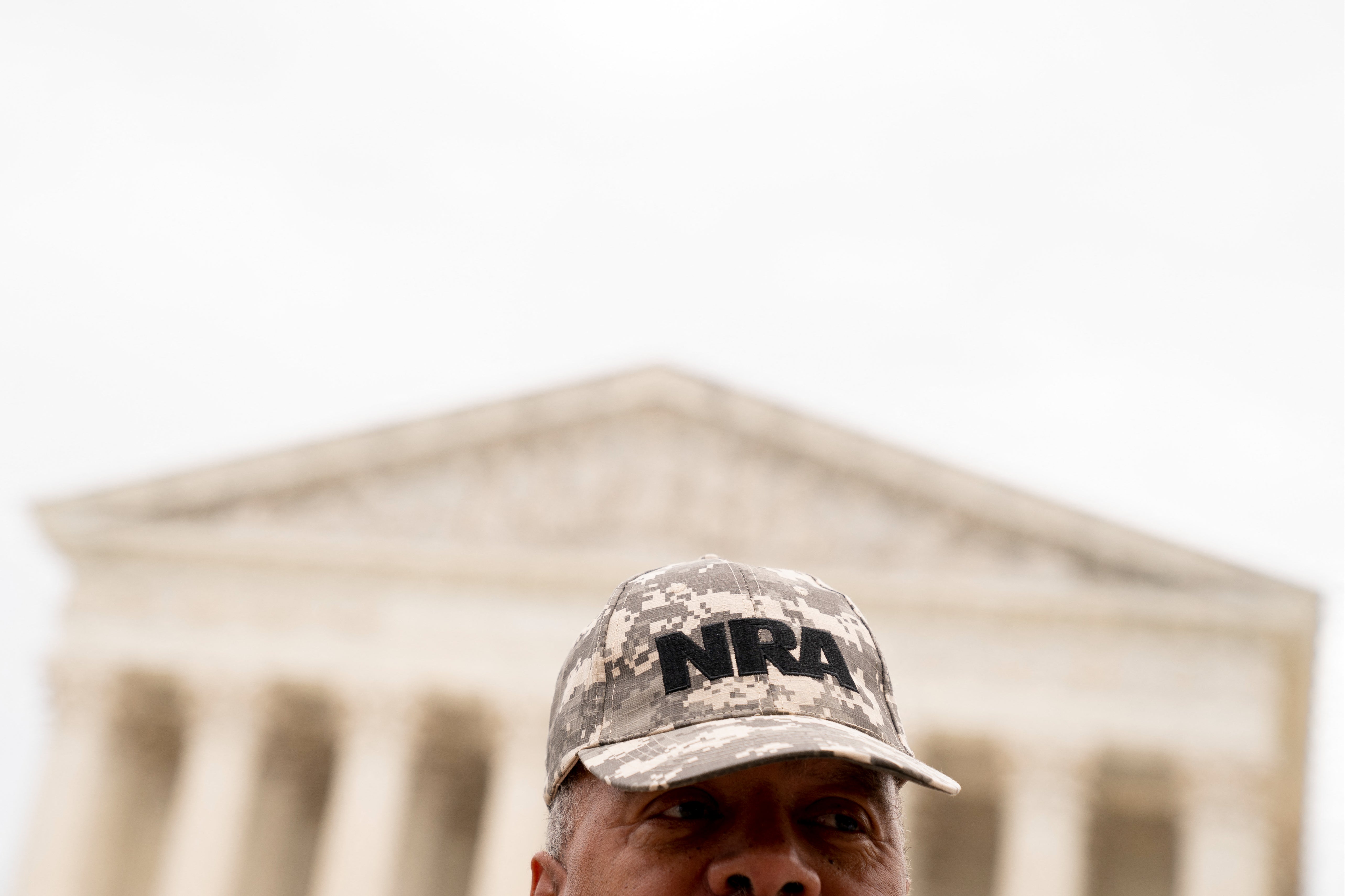 A person wears an NRA hat in front of the US Supreme Court in Washington, DC