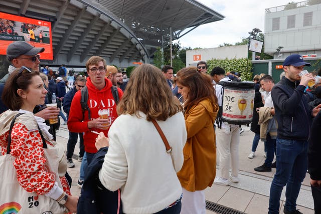 Fans drank outside Court Phillipe Chatrier after French Open bosses banned beer in the stands (Jean-Francois Badias/AP)
