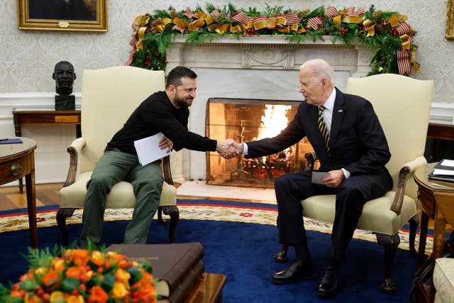 <p>Ukrainian President Volodymyr Zelensky (L) and U.S. President Joe Biden shake hands while meeting in the Oval Office at the White House on 12 December 2023 in Washington, DC</p>