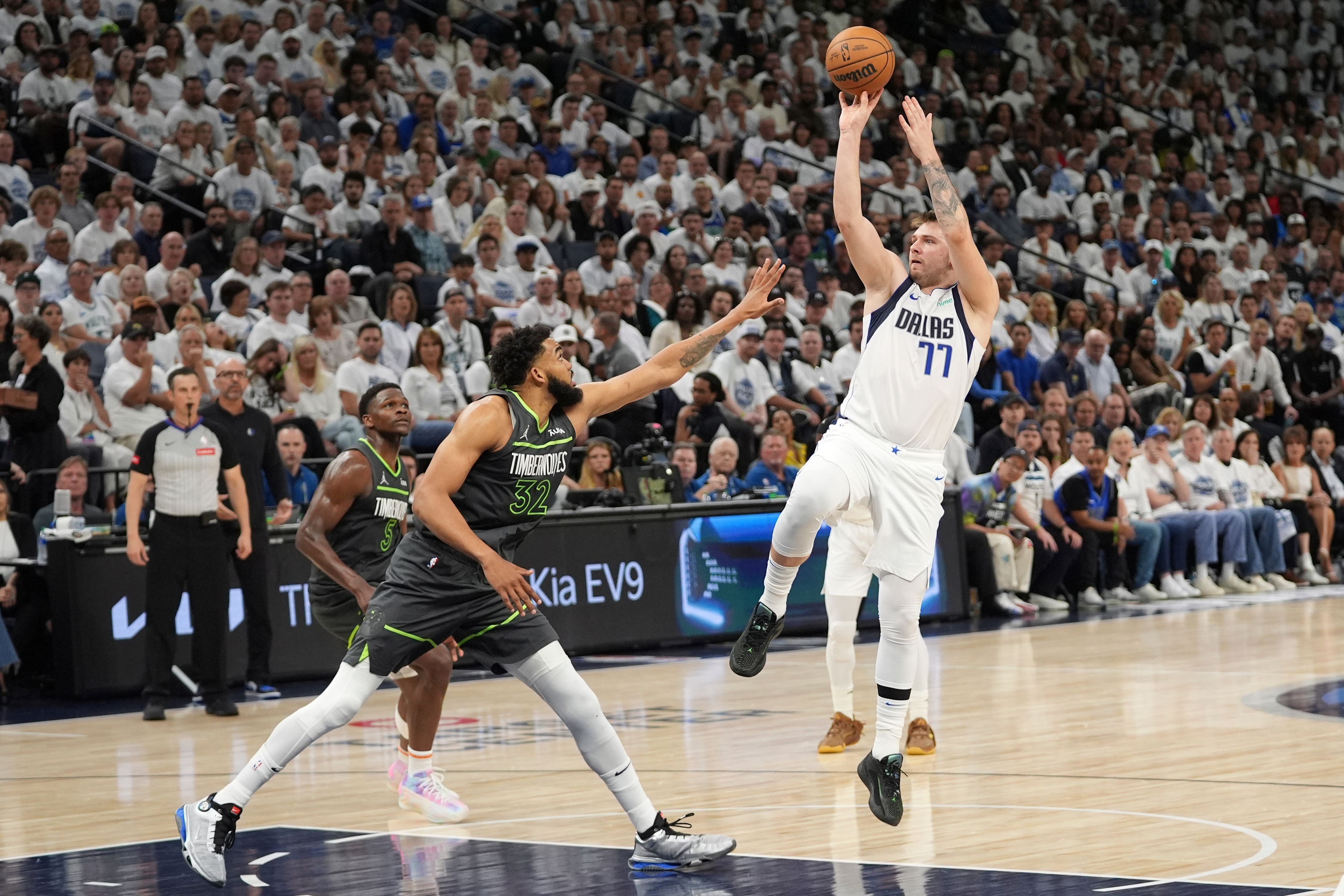 Dallas Mavericks guard Luka Doncic (77) shoots over Minnesota Timberwolves centre Karl-Anthony Towns (32) (Abbie Parr/AP)