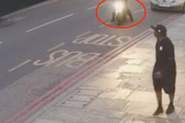 <p>CCTV image shows the moment a motorcyclist launched the attack </p>