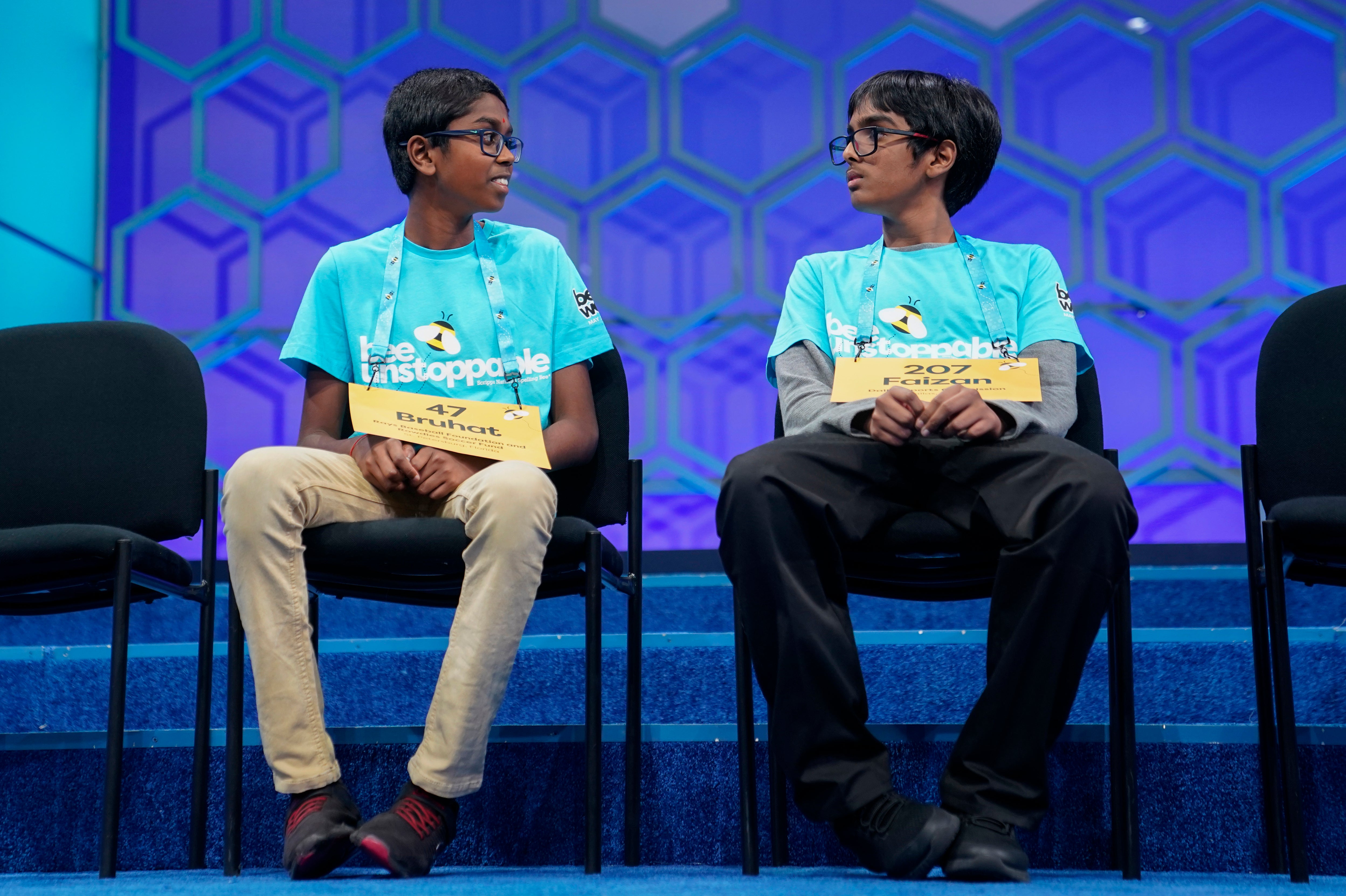 Bruhat Soma, 12, of Tampa, Fla., left, and Faizan Zaki, 12, of Allen, Texas, right, sit together after competing in a spell-off during the finals of the Scripps National Spelling Bee, in Oxon Hill, Md., Thursday, May 30, 2024. (AP Photo/Nathan Howard)