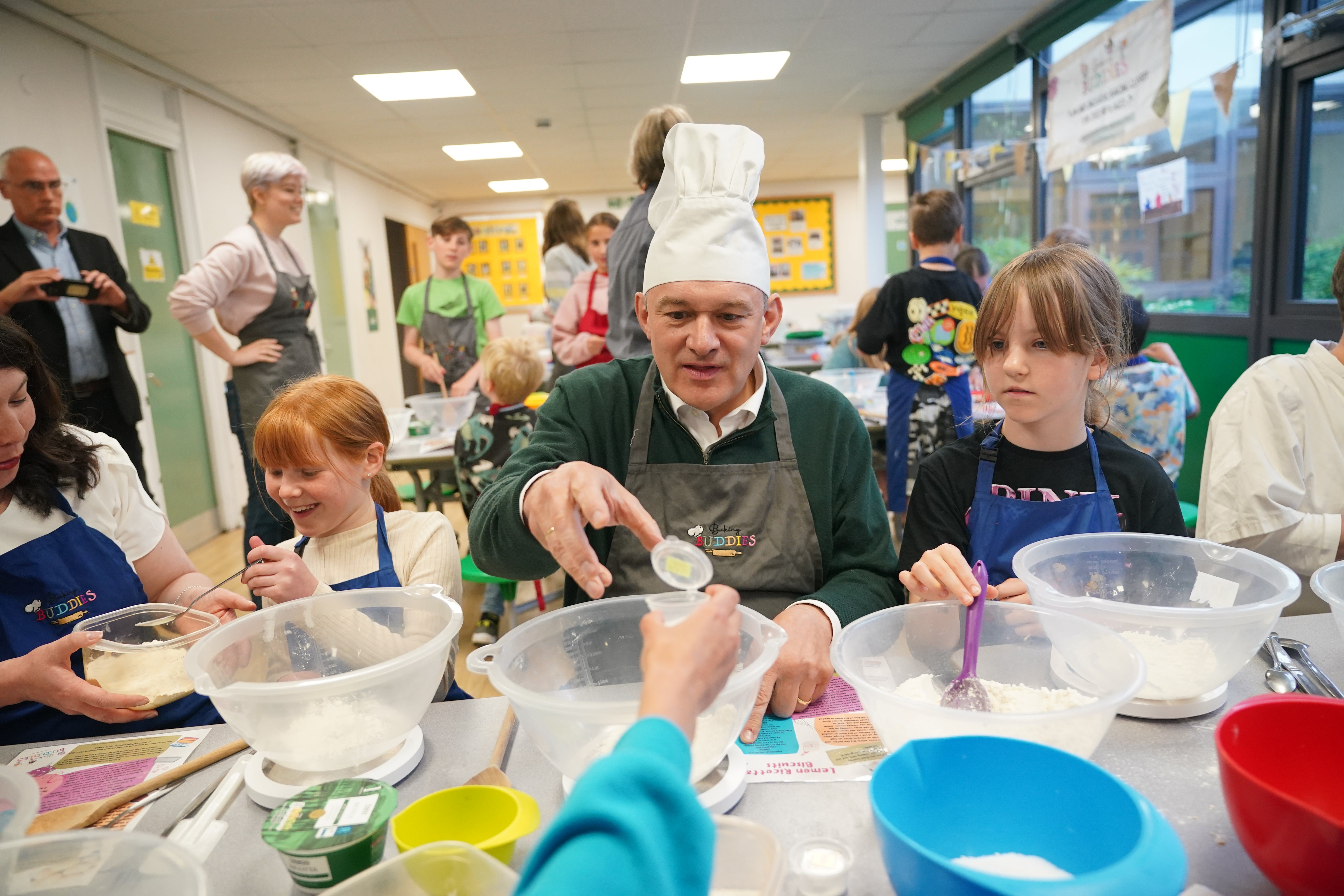 Liberal Democrats leader Sir Ed Davey taking part in a baking lesson with students from High Beeches Primary School during a half-term holiday camp in Hertfordshire, while on the General Election campaign trail