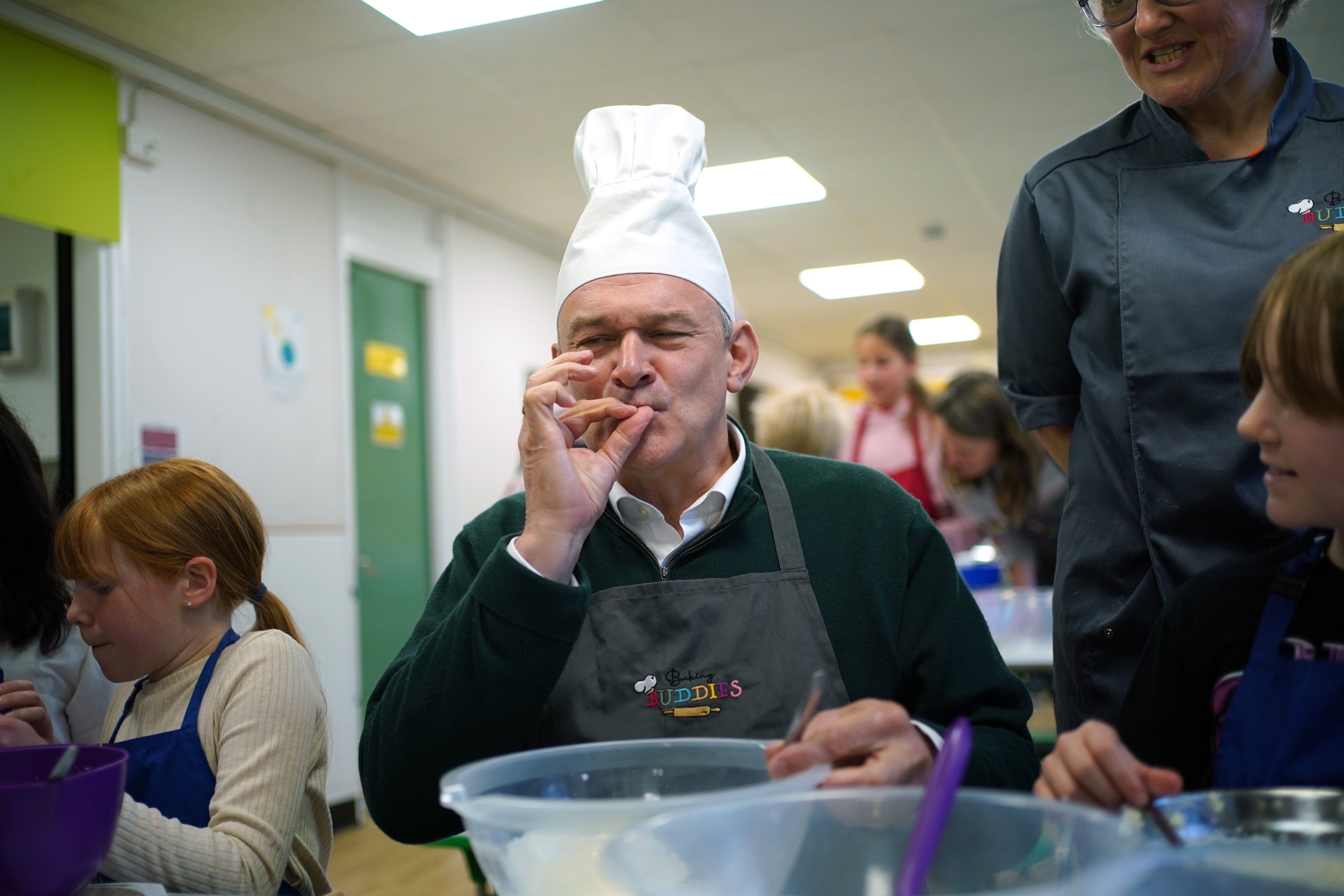 Liberal Democrats leader Sir Ed Davey taking part in a baking lesson with students from High Beeches Primary School during a half-term holiday camp in Hertfordshire