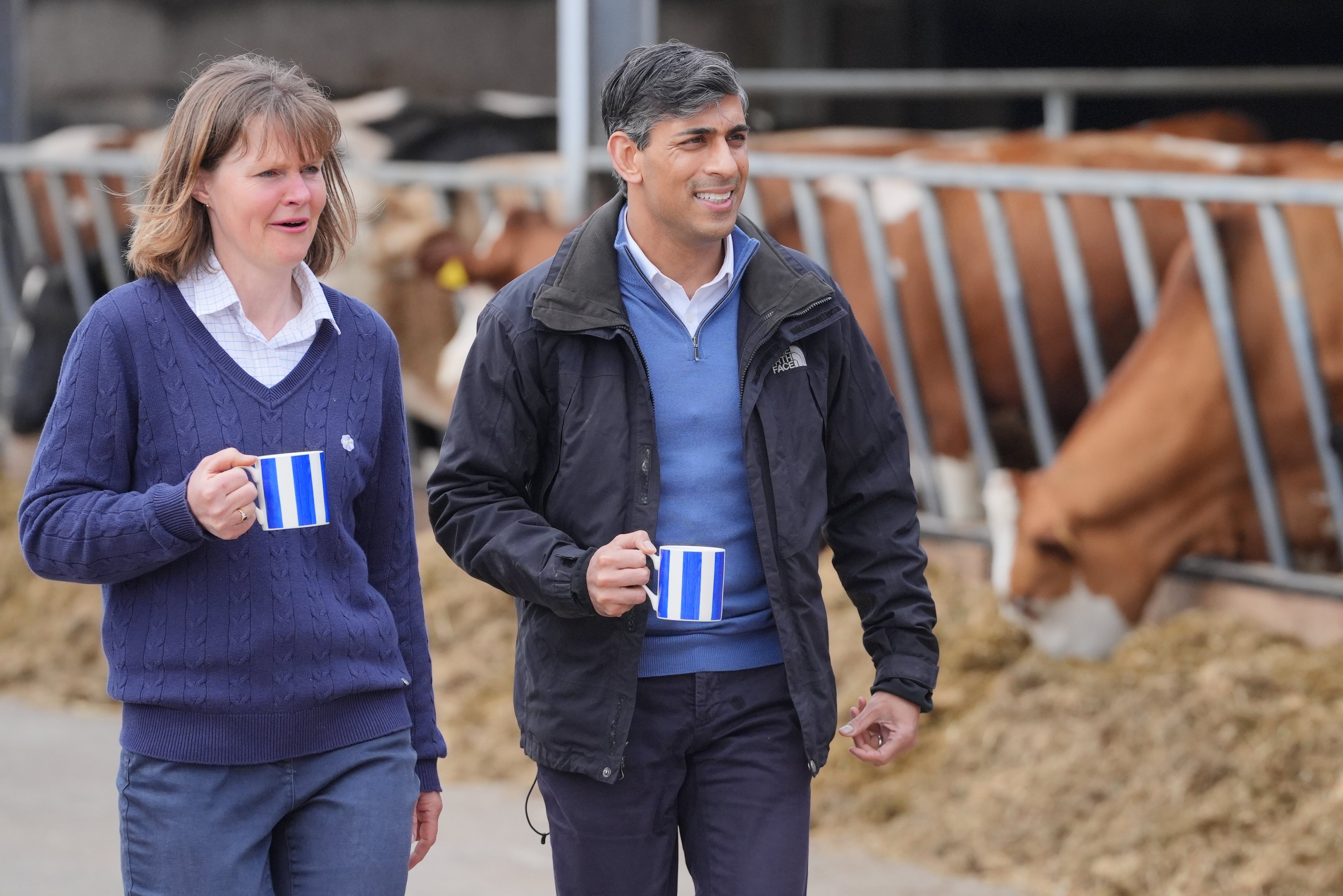 Prime Minister Rishi Sunak walks with farm owner Rachel Rowlinson, during a visit to Rowlinson's Farm