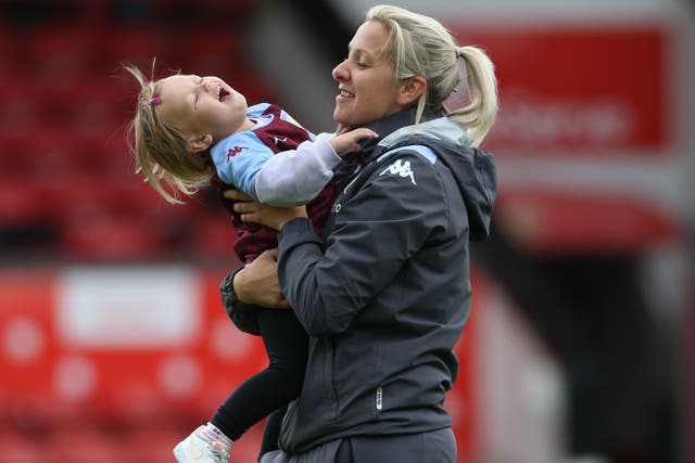 Aston Villa manager Carla Ward with her daughter on the pitch (Barrington Coombs/PA)