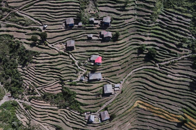<p>A drone view shows houses in Almi, the village hosting a remote polling station, ahead of the seventh and final phase of the general election</p>